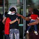 Mourners embrace as they leave a wake for Stephon Clark at the Boss Church on March 28, 2018, in Sacramento, Calif.